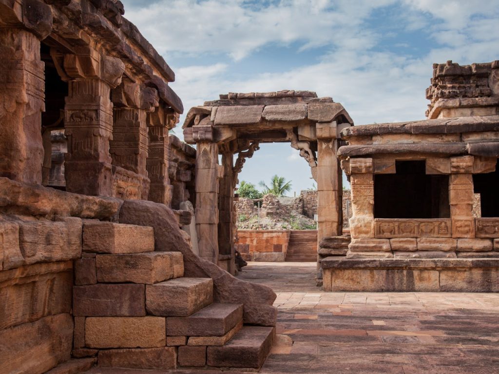 Discover the intricate stone architecture of an ancient Hindu temple in Aihole, India.